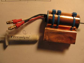 04-02-14: I used a Himax 2025-3200 inrunner for power.&nbsp; Here it is
with the homemade heat sink installed.&nbsp; The heat sink is a
rectangular piece of .005" copper sheet.&nbsp; I think it is seven
inches long, the full length of the K&S Precision metals stock that I
bought (#15058 1piece each of brass, aluminum and copper).<br><br>

I loosely folded the copper sheet in the middle and put the motor in
the fold.&nbsp; Now the sheet is U shaped.&nbsp; Then I pressed the two
legs of the U together, fully enclosing the motor.&nbsp; I pierced the
two legs of the U in three places to allow three zip ties to be
threaded through, but I didn't install them yet.<br><br>

Next I gently bent the U open enough to remove the motor.&nbsp; I
smeared Ceramique heat sink compound (from a computer store) on the
case of the motor (after first removing the label from the motor), and
I carefully put the motor back into the U.  I pressed the U closed and
installed the three zip ties, pulling them tight.&nbsp; The location of
the zip fasteners is important, since the pod is just slighly bigger
than the motor.&nbsp; The zip fasteners go in one of the upper two
corners of the pod (where the sides meets the top), so position the zip
ties this way before you fully tighten them.&nbsp; Likewise you should
position the motor how you want it.&nbsp; I installed mine with the two
mounting holes horizontal (left and right of the shaft).<br><br>

Finally I wiped away the extra heat sink compound and shaped each of
the two legs of the U into an S shape.